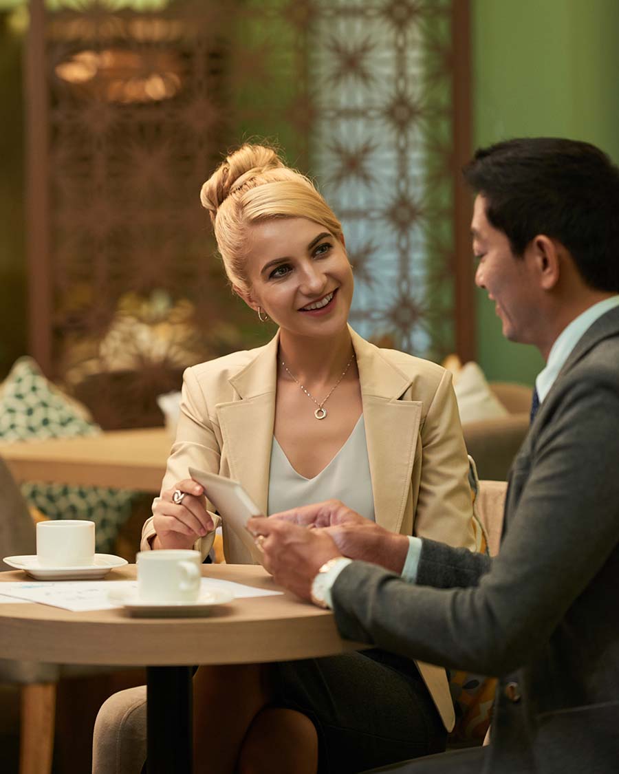 Professional singles having a thoughtful conversation in an elegant lounge