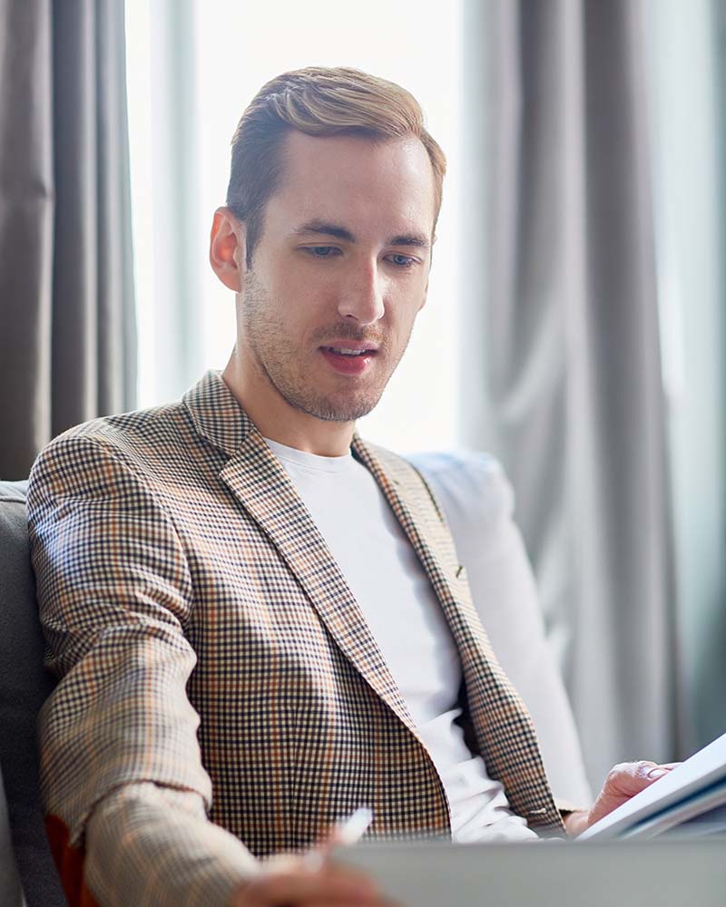 Elite bachelor in finance wearing a tailored suit